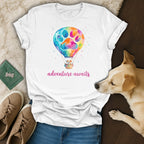 White t-shirt with watercolor hot air balloon, dog, and text "adventure awaits".