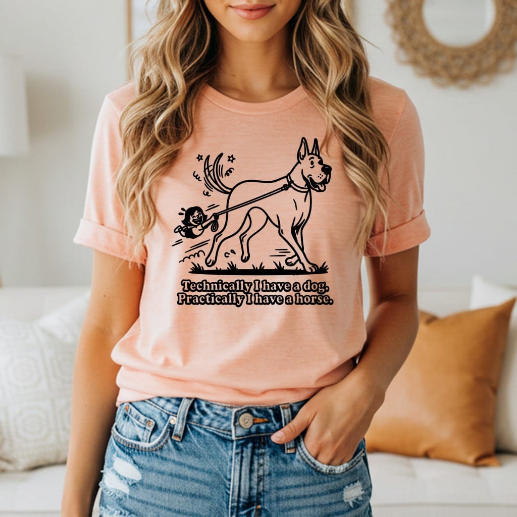 Peach t-shirt with illustration of a small person walking a large dog, text reads "Technically I have a horse."