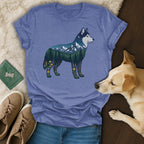 Blue t-shirt with husky silhouette filled with mountains, trees, and flowers.