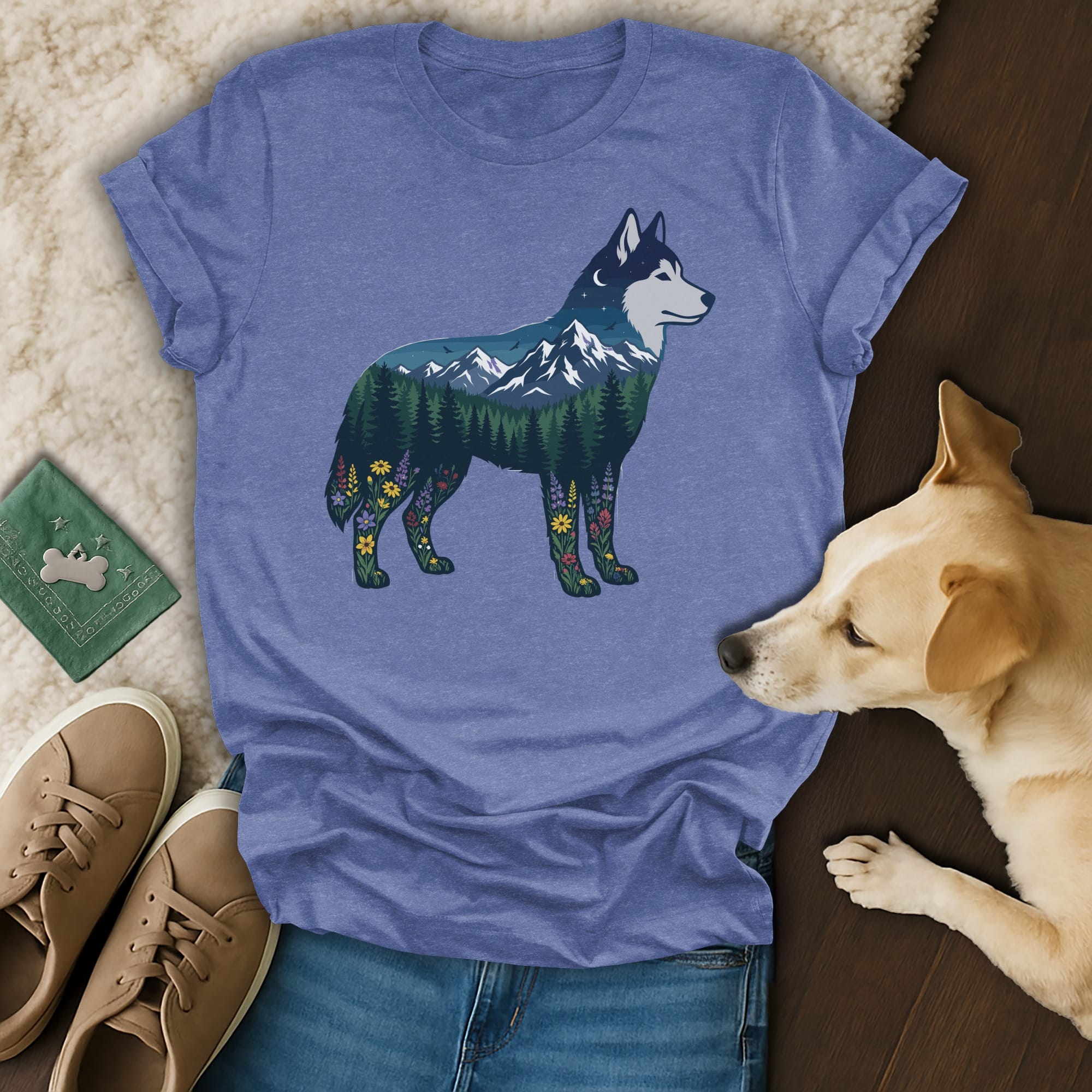 Blue t-shirt with husky silhouette filled with mountains, trees, and flowers.