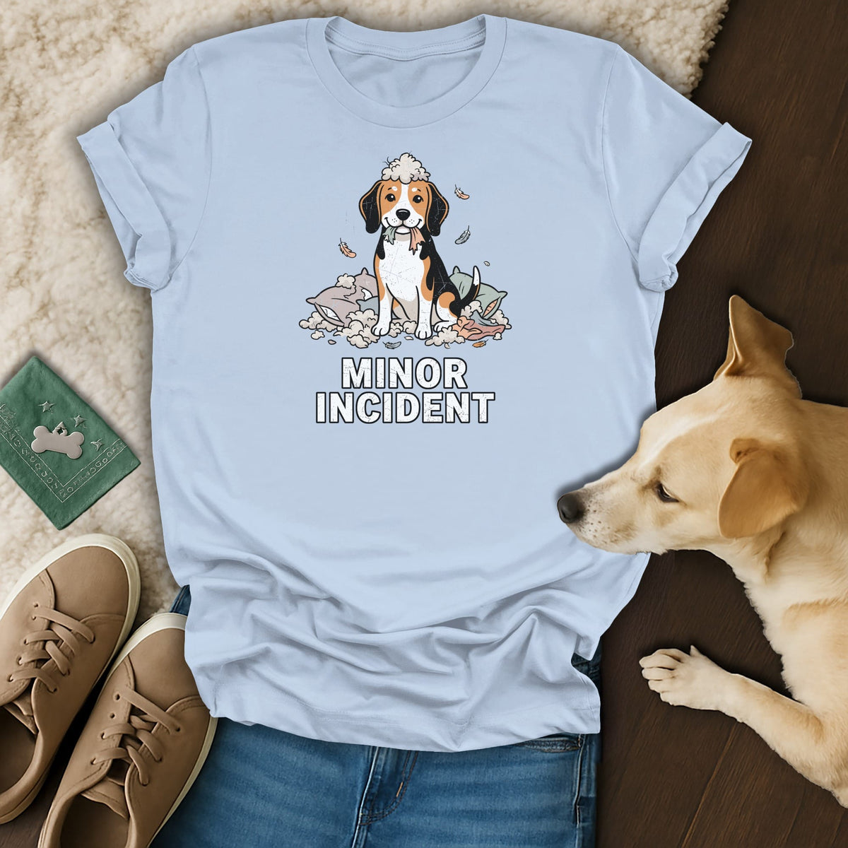 Light blue t-shirt with cartoon dog sitting in ripped pillows, text "Minor Incident".