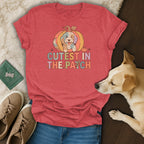 Red t-shirt with "Cutest in the Patch" text and a dog inside a pumpkin.