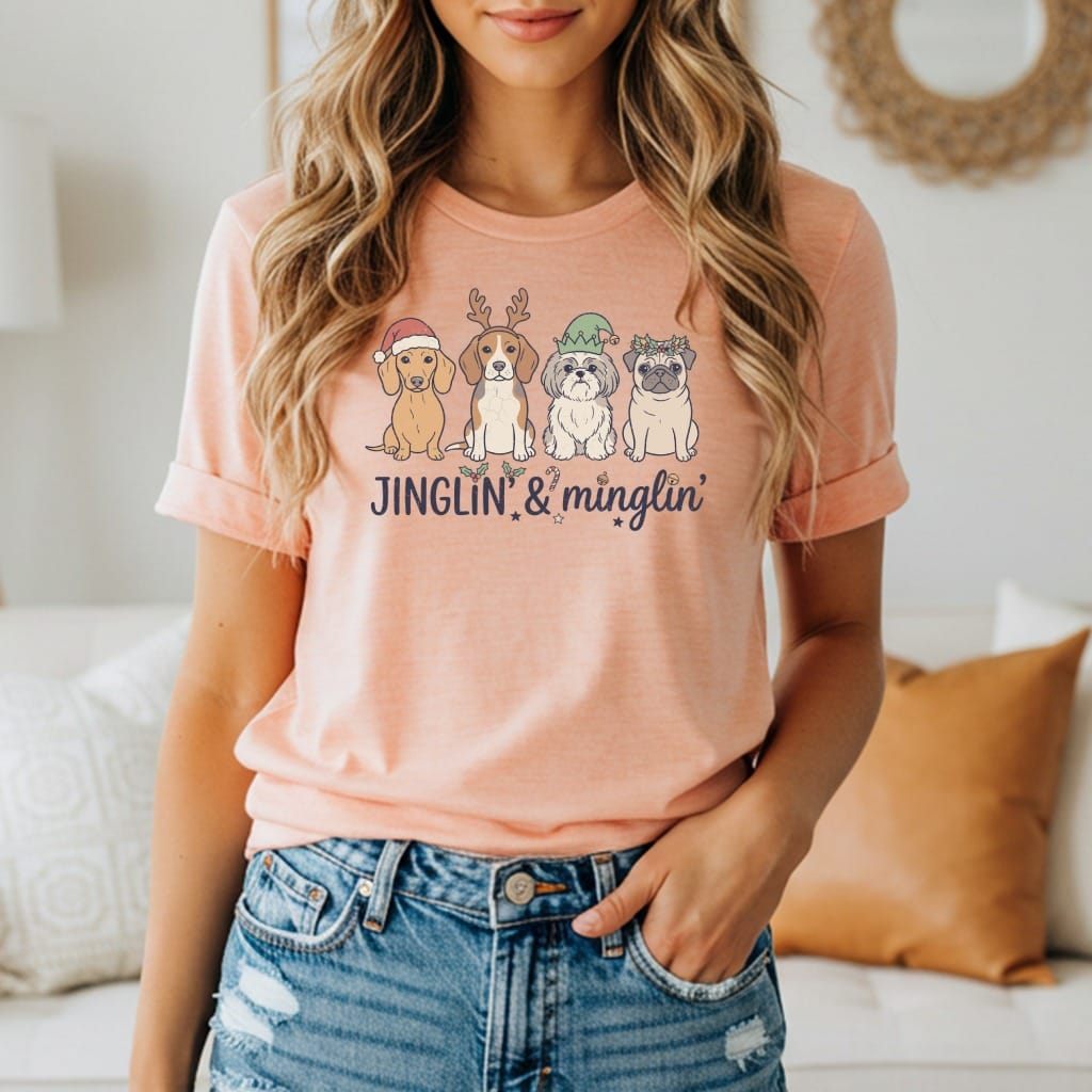 Peach t-shirt with four dogs in Christmas hats and text "JINGLIN' & mingling'".