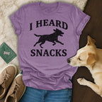 Purple t-shirt with black dog silhouette and text "I HEARD SNACKS".