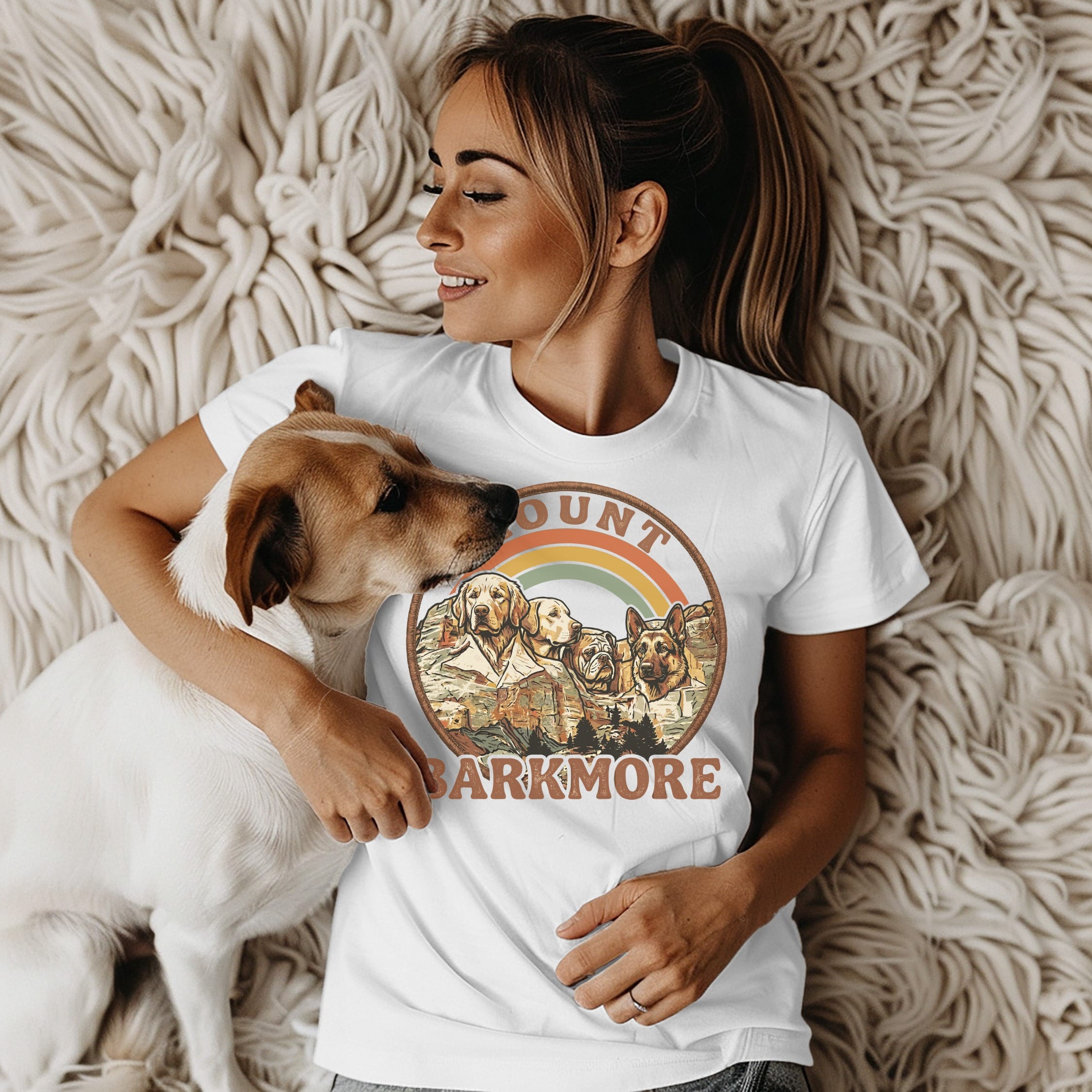Woman wearing a t-shirt with dogs and "Barkmore" text.