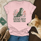 Pink t-shirt with a graphic of a Bernese Mountain Dog and flowers, featuring the text GROWS BEST BESIDE YOU.