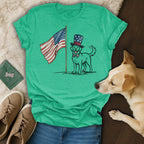Golden retriever wearing a top hat and bowtie stands by an American flag.