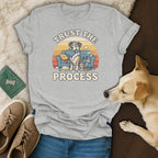 Grey t-shirt with distressed graphic of dog on couch, text "TRUST THE PROCESS".