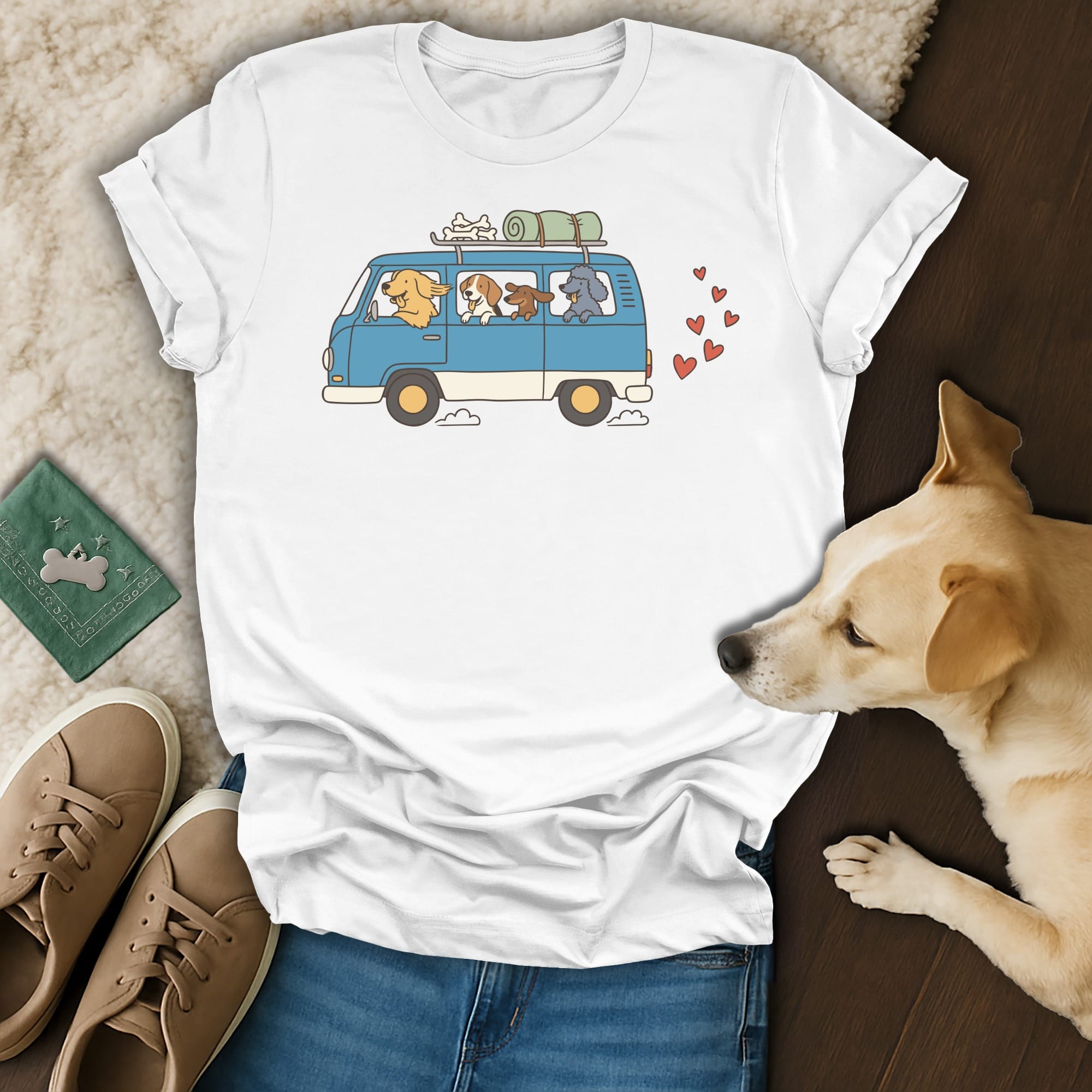 White t-shirt with cartoon dogs in a blue van and red hearts graphic.