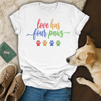 White t-shirt with "love has four paws" text and paw prints.