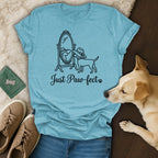 Light blue t-shirt with a dog looking in a mirror, text "Just Paw-fect".