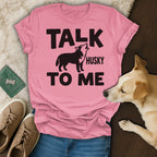 Pink t-shirt with "TALK HUSKY TO ME" text and a howling husky graphic.