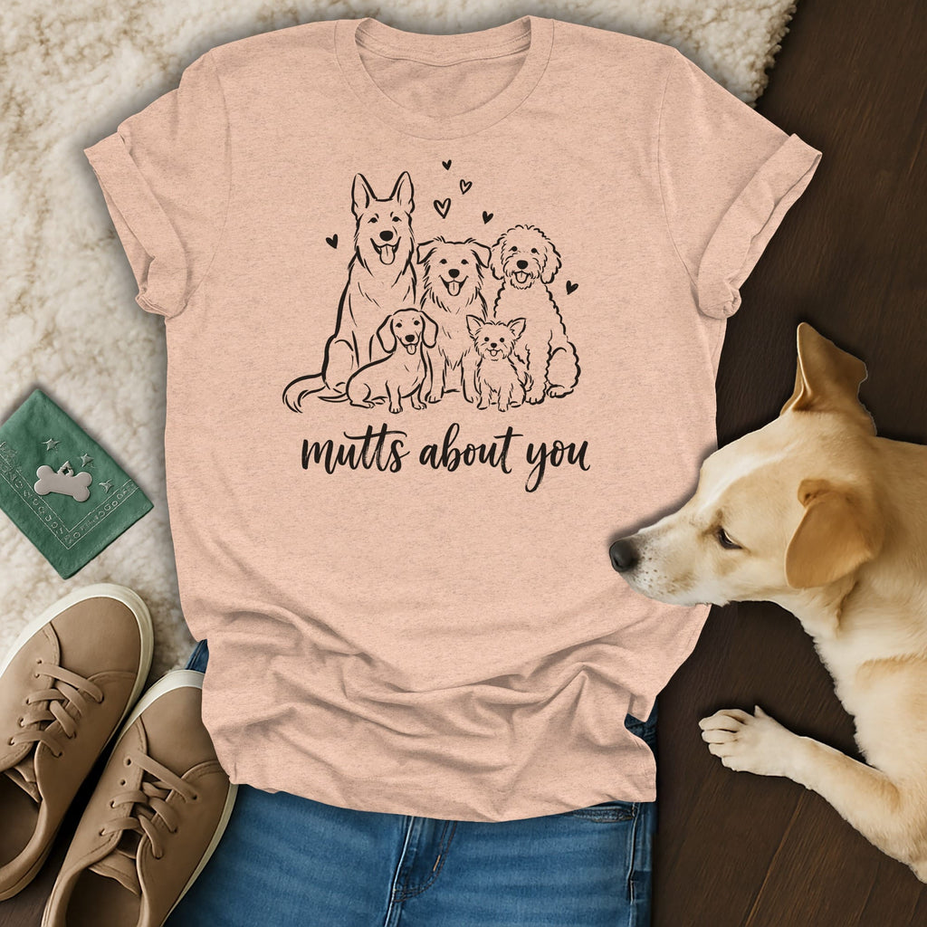 Peach t-shirt with a line drawing of five dogs and "mutts about you" text.