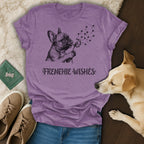 Purple t-shirt with French bulldog blowing dandelion seeds that form paw prints.