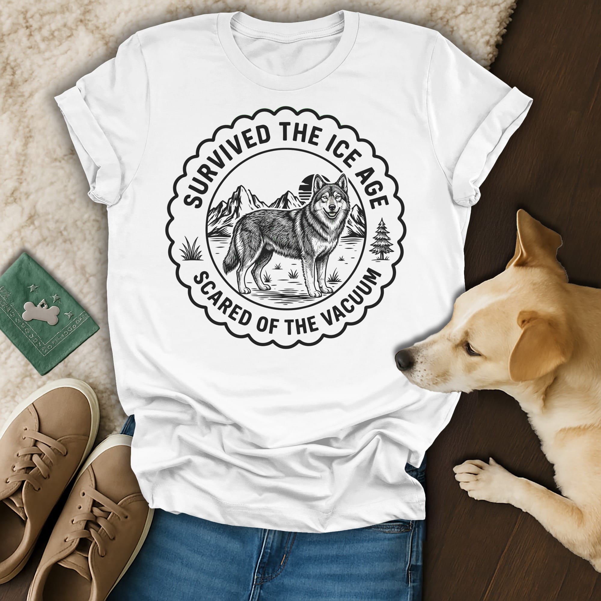 White t-shirt with wolf and mountains graphic reading "Survived the Ice Age Scared of the Vacuum."