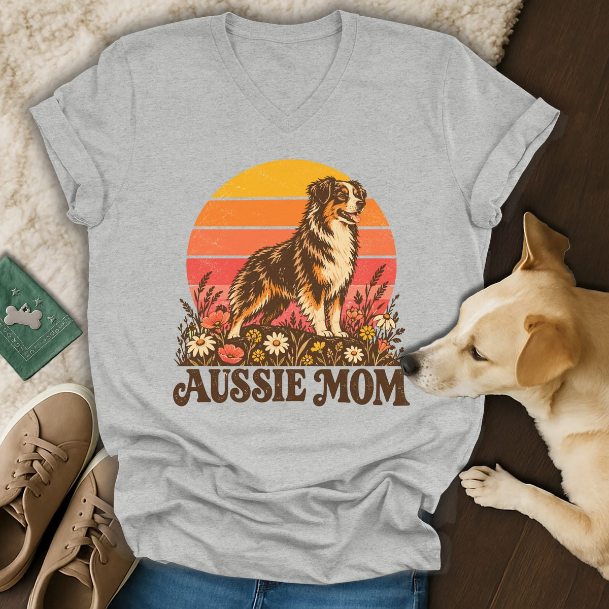 Heather gray V-neck t-shirt featuring a retro sunset design with an Australian Shepherd and flowers, text reading AUSSIE MOM.