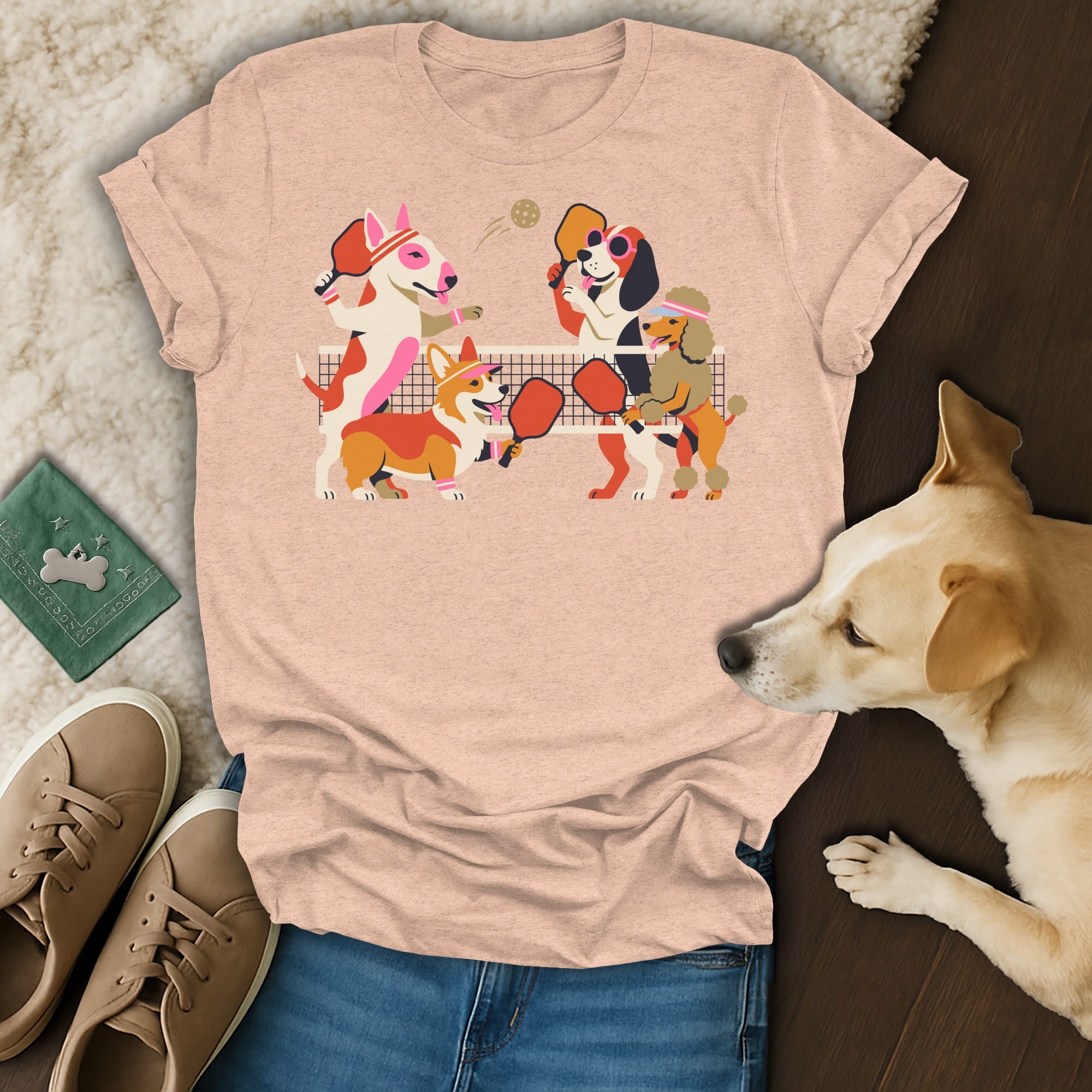 T-shirt with cartoon dogs playing pickleball on a net.