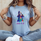 Blue t-shirt with a colorful dog silhouette and "shake it off" text.