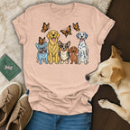 Five dogs in a row, with butterflies above, on a t-shirt.