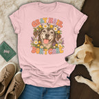 A pink t-shirt with a graphic of an elderly dog wearing a floral crown and the text Gray Hair Don't Care.