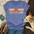 Retro t-shirt with silhouettes of five dogs and a sunset design.