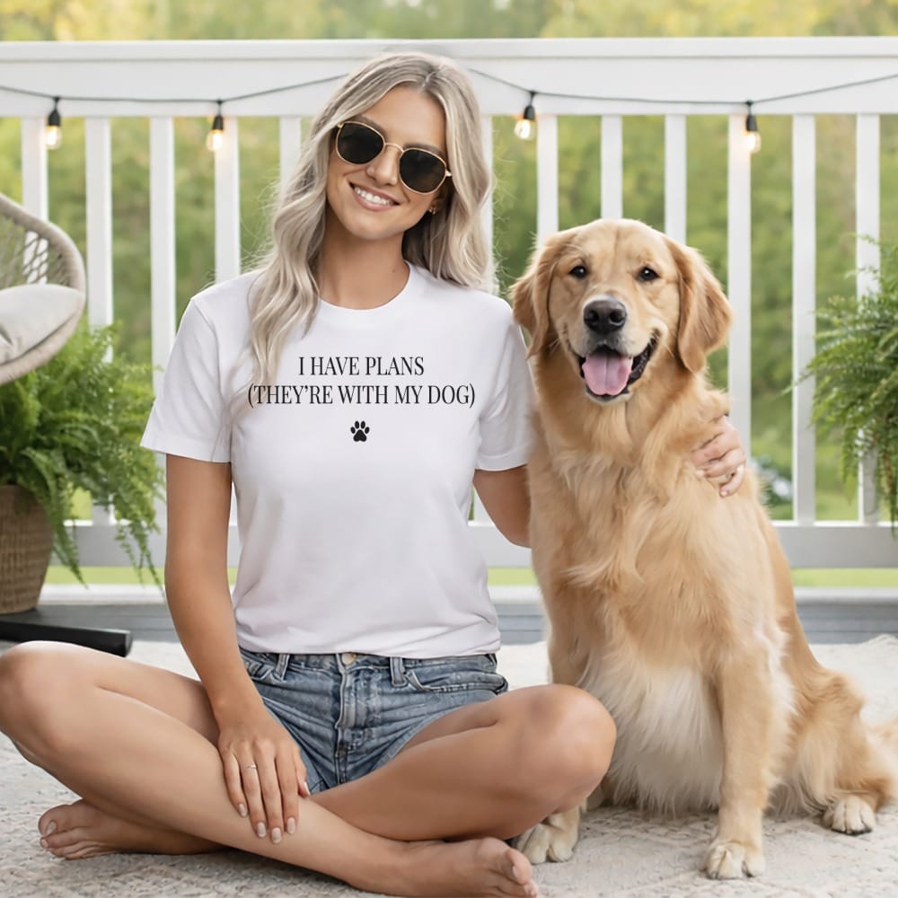 White t-shirt with text "I HAVE PLANS (THEY'RE WITH MY DOG)" and paw print.