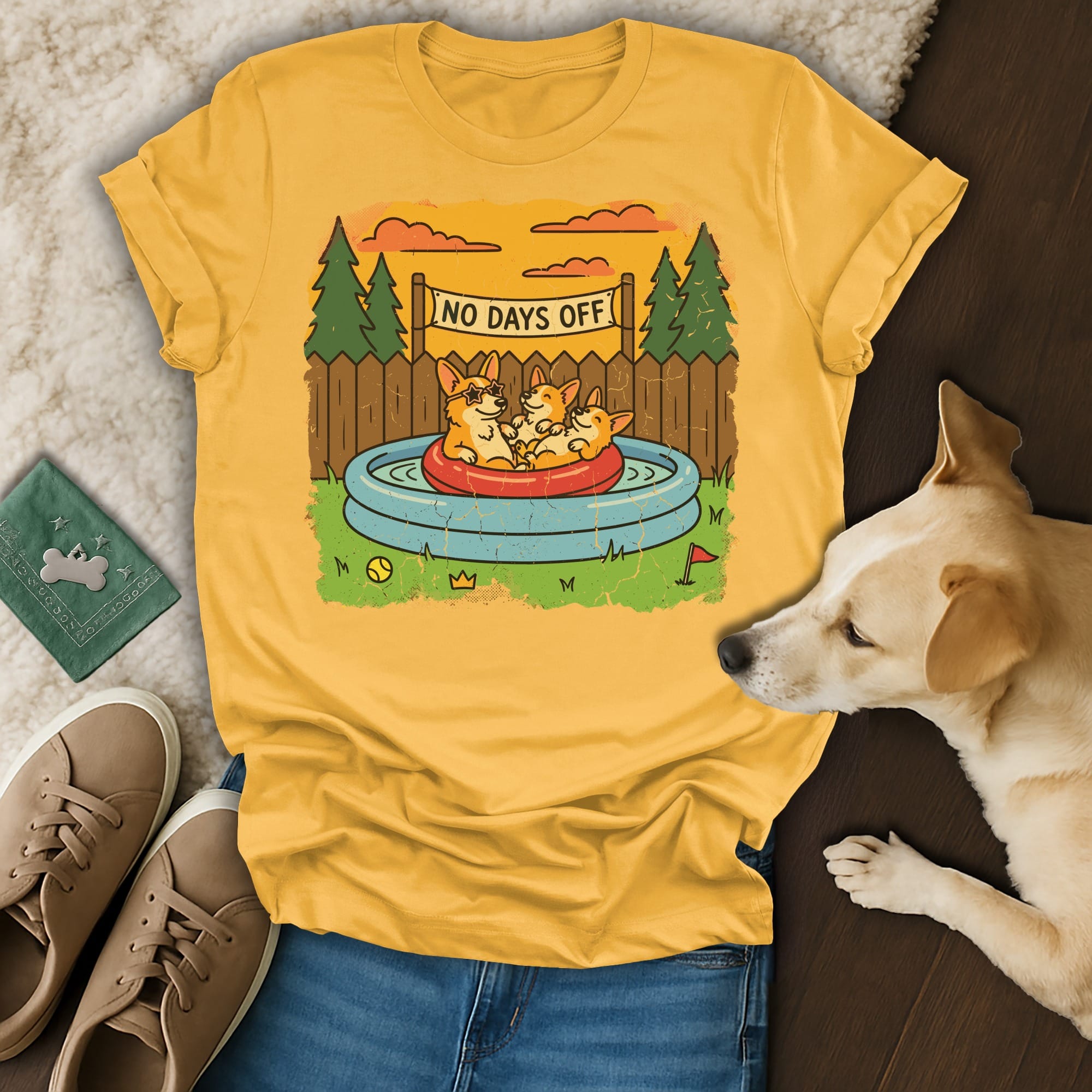 Yellow t-shirt with three corgis in a kiddie pool and text that reads "No Days Off".