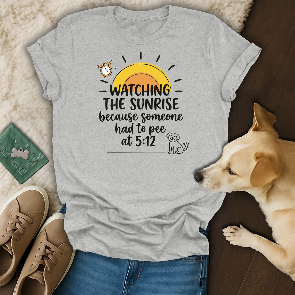 Grey t-shirt with "Watching The Sunrise because someone had to pee at 5:12" graphic.