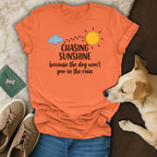 Orange t-shirt with "Chasing Sunshine because the dog won't poo in the rain" text.