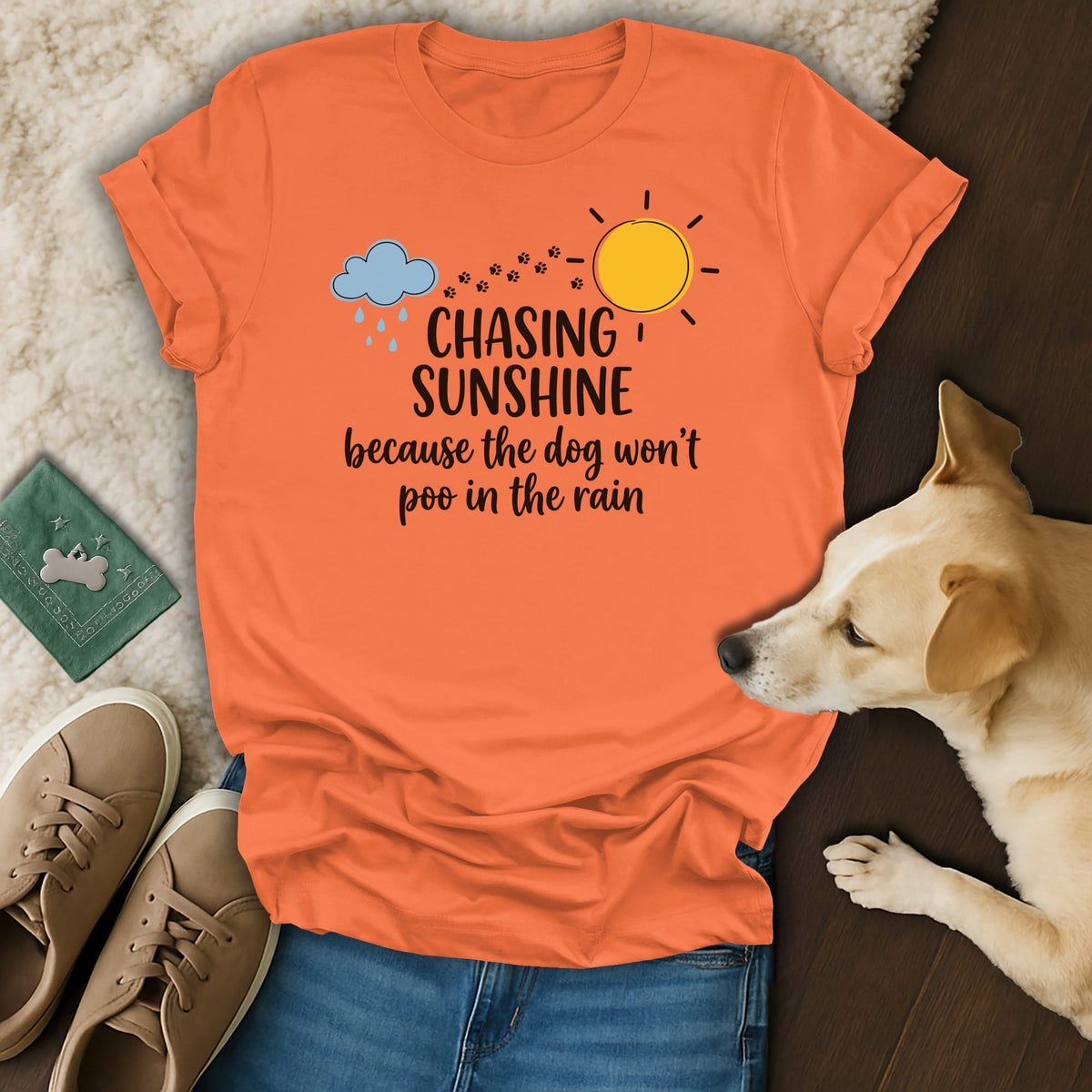 Orange t-shirt with "Chasing Sunshine because the dog won't poo in the rain" text.