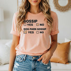Peach t-shirt with black text reading "GOSSIP YES NO" with "NO" checked, and "DOG PARK GOSSIP YES NO" with "YES" checked.