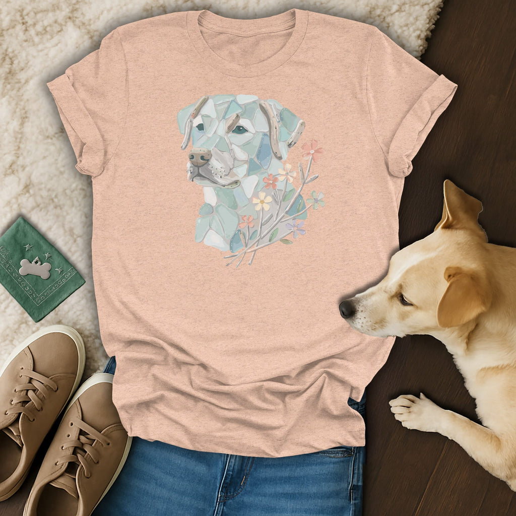 Peach t-shirt with mosaic dog and floral design, laid flat.