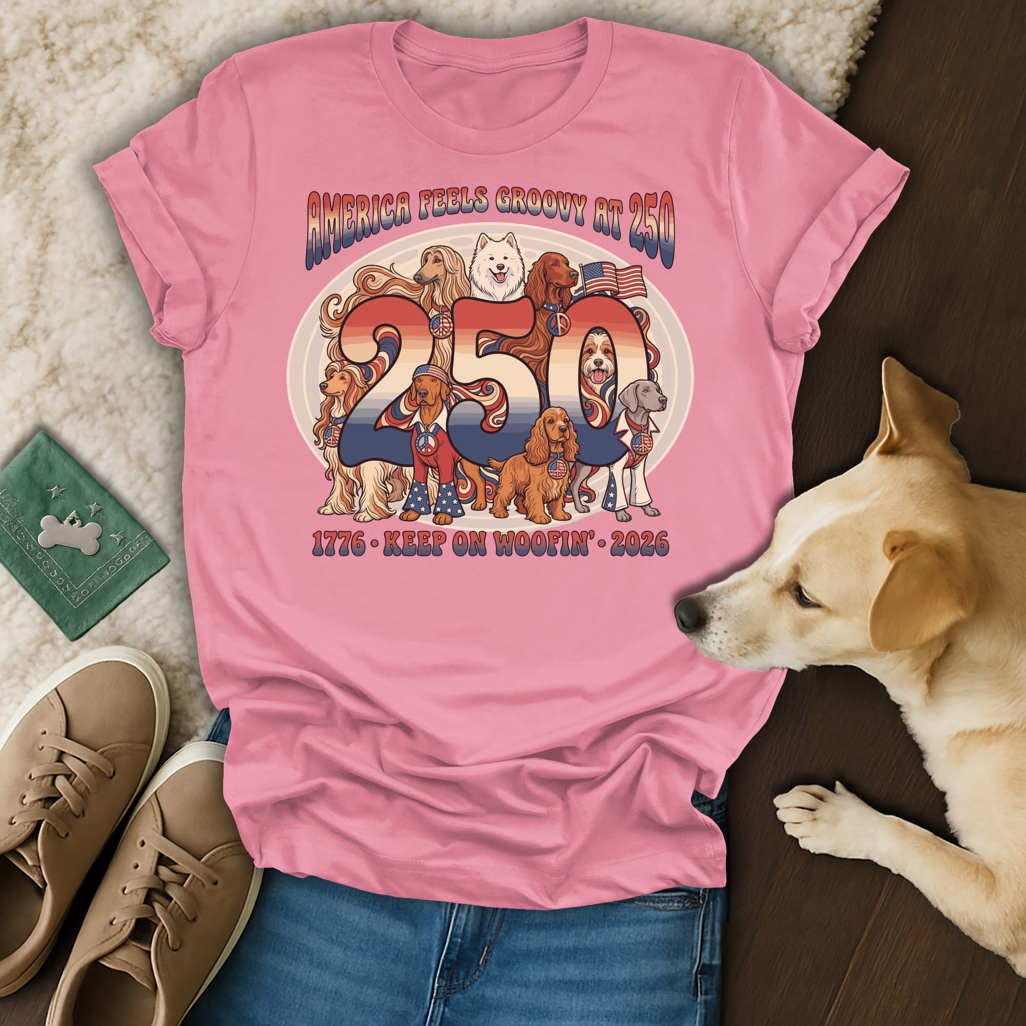 Pink t-shirt with "America Feels Groovy 'til 250" and dogs, 1776-2026.
