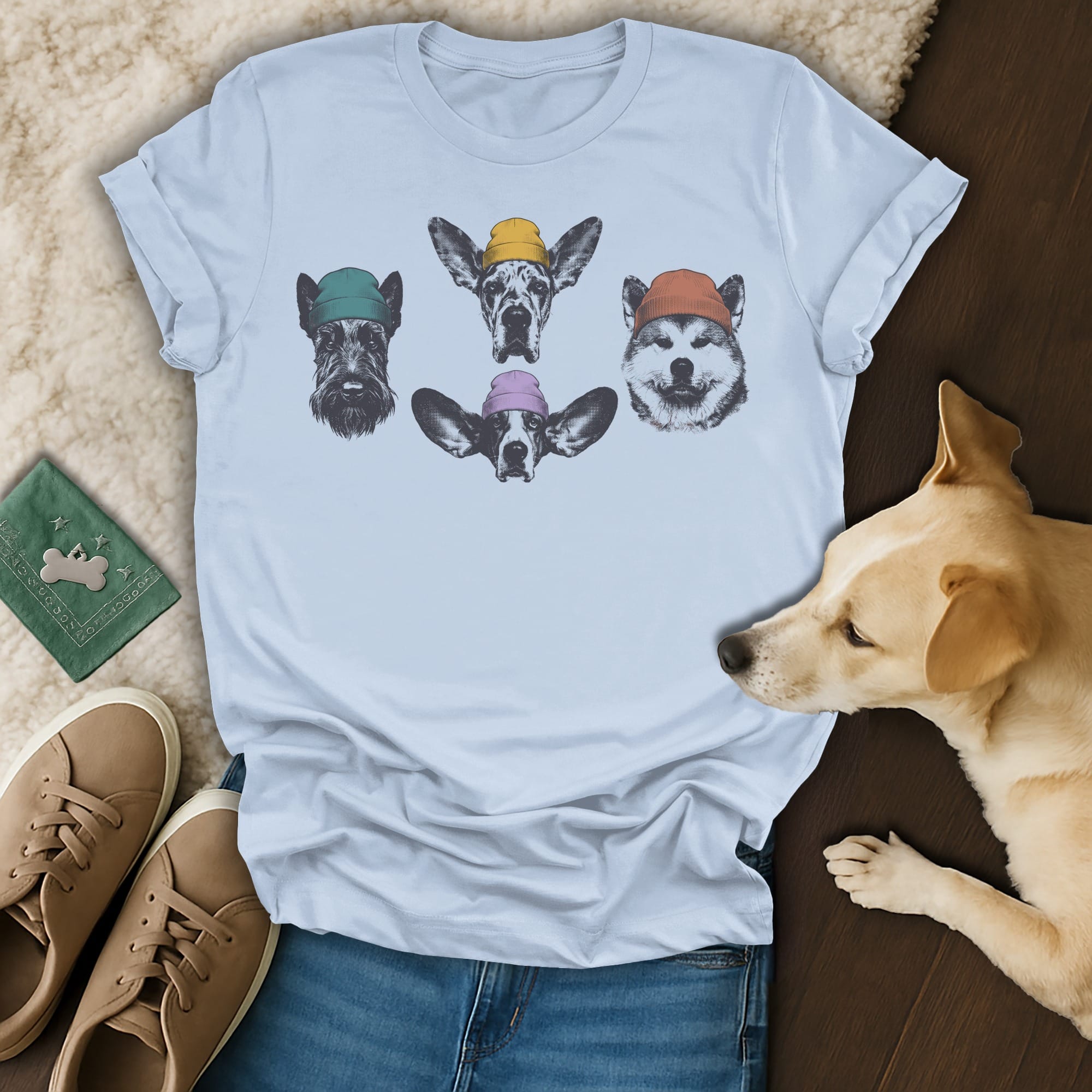 Five dog heads wearing knitted hats on a light blue t-shirt.