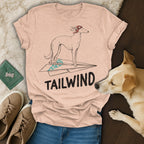 Light pink t-shirt with a dog on a paper airplane and "TAILWIND" text.