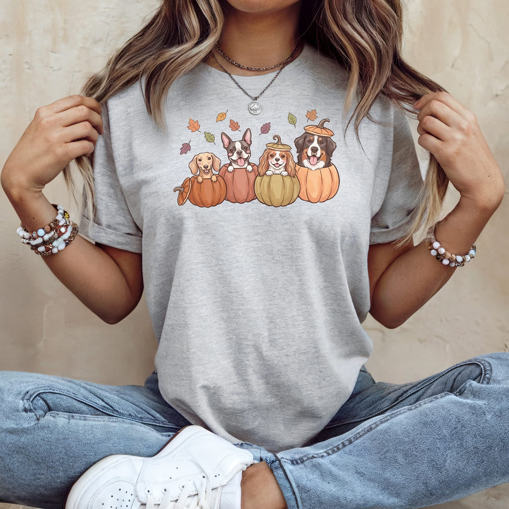 Four dogs in pumpkins with fall leaves on a grey t-shirt.