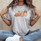 Four dogs in pumpkins with fall leaves on a grey t-shirt.