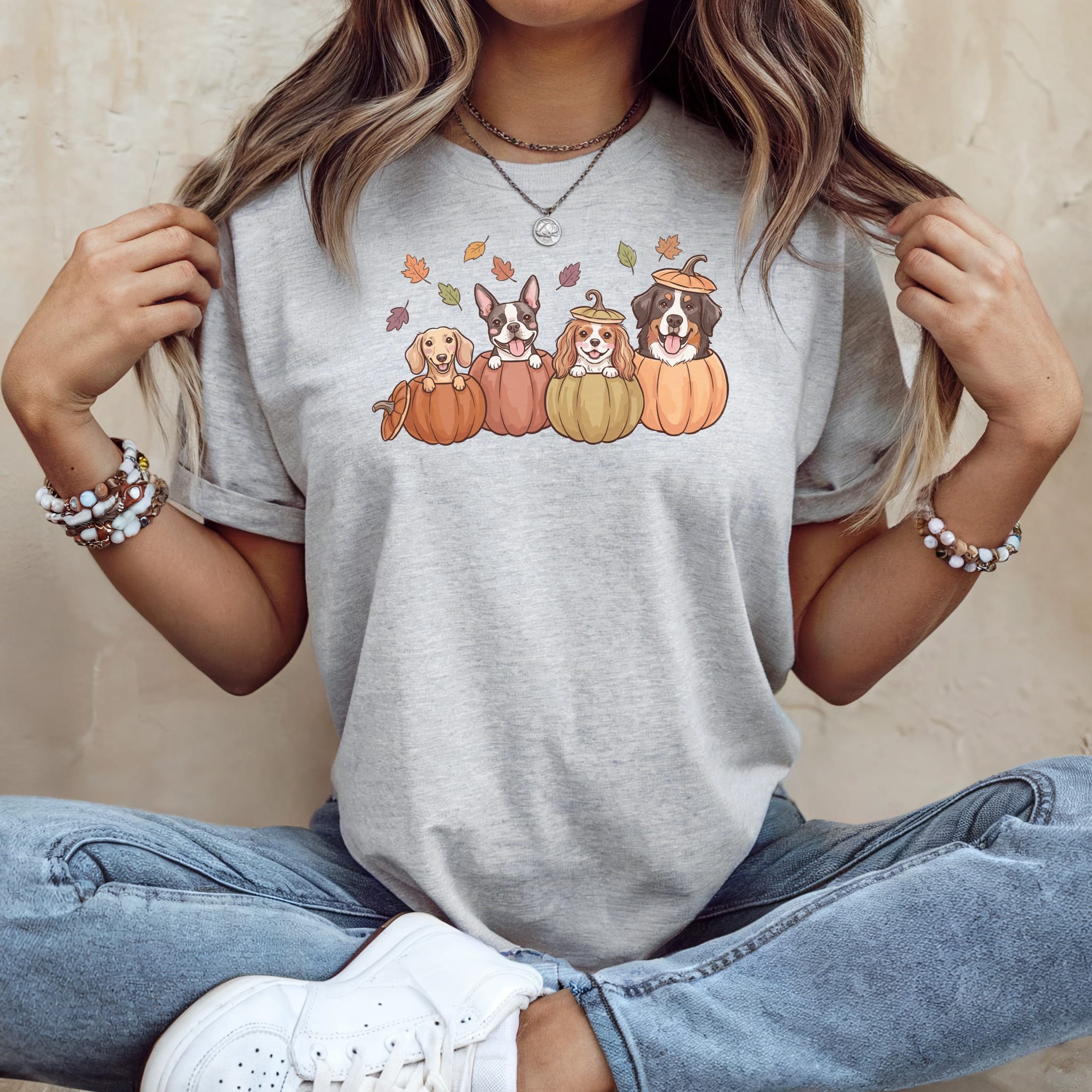Four dogs in pumpkins with fall leaves on a grey t-shirt.