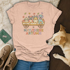 Peach t-shirt with cartoon dogs in a wagon, autumn leaves, and text "Hay There Autumn".