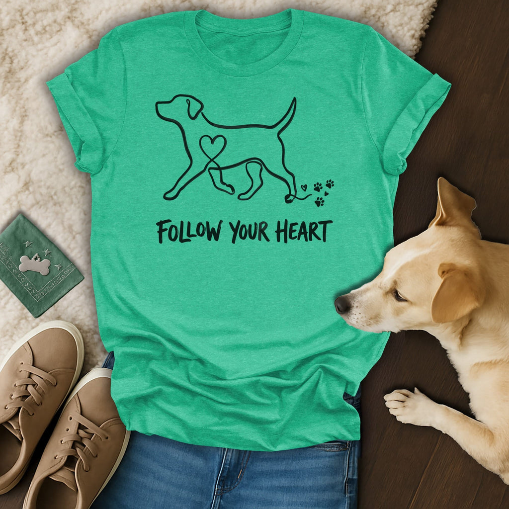 T-shirt with dog graphic and "Follow Your Heart" text, dog and shoes nearby.
