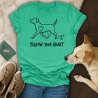 T-shirt with dog graphic and "Follow Your Heart" text, dog and shoes nearby.