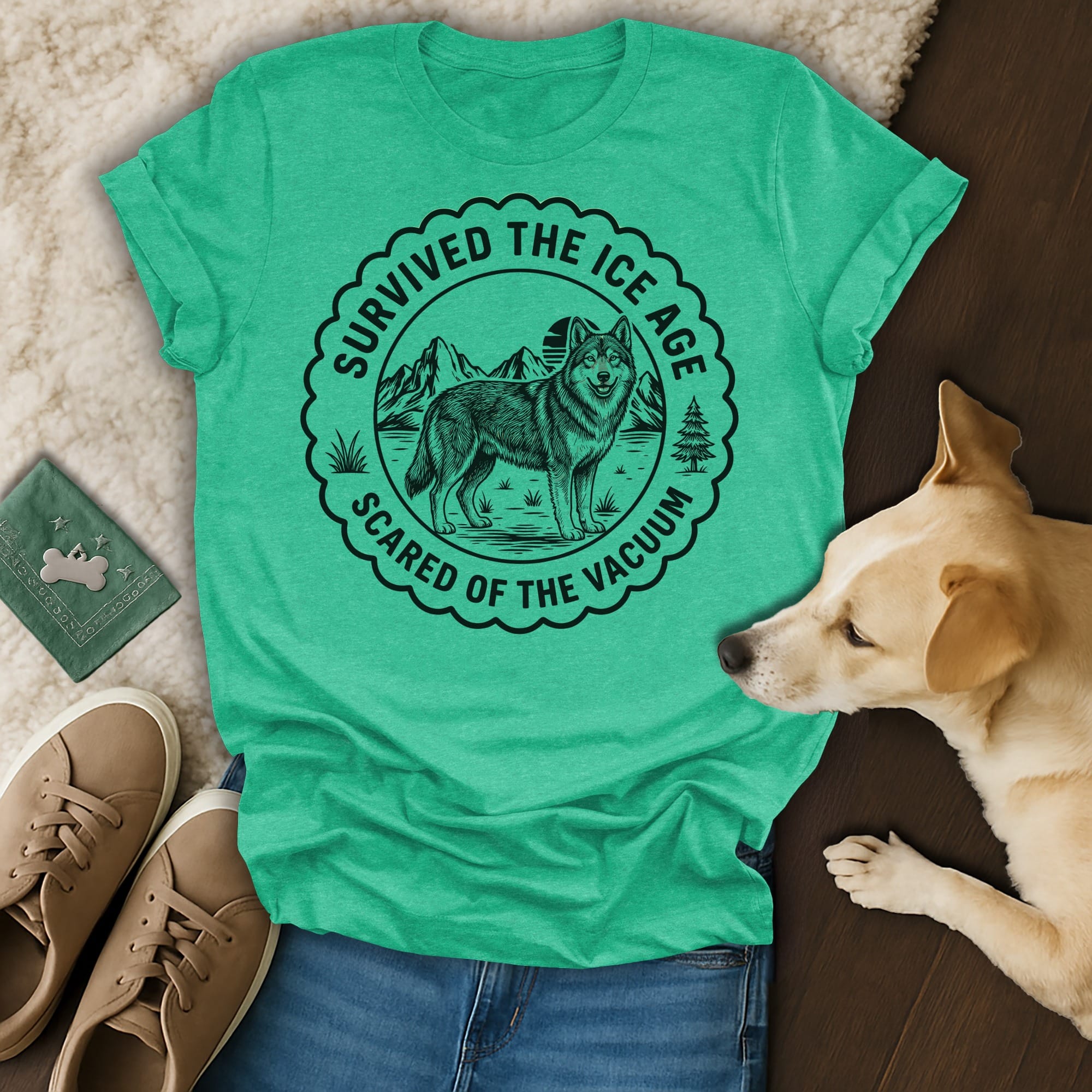 Green t-shirt with "Survived the Ice Age, Scared of the Vacuum" text and wolf graphic.