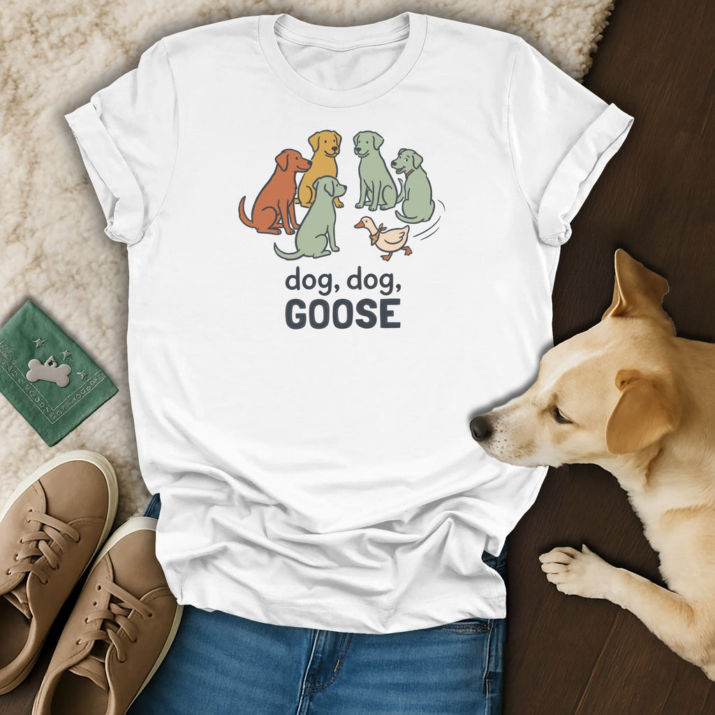 White t-shirt with cartoon dogs playing "dog, dog, goose" with a duck.