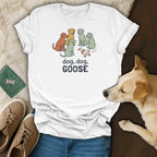 White t-shirt with cartoon dogs playing "dog, dog, goose" with a duck.
