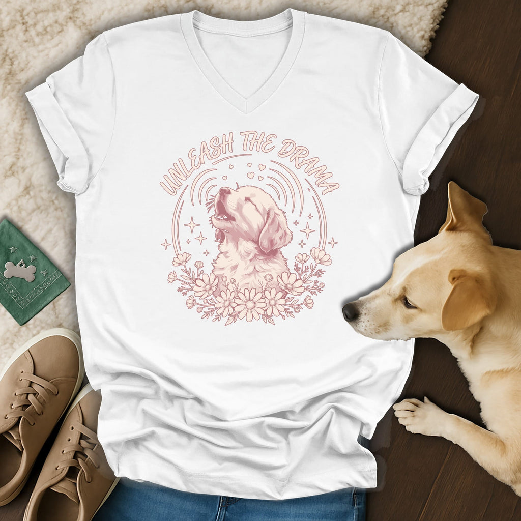 White t-shirt with a drawing of a dog howling surrounded by flowers and stars, reads "Unleash the Drama".