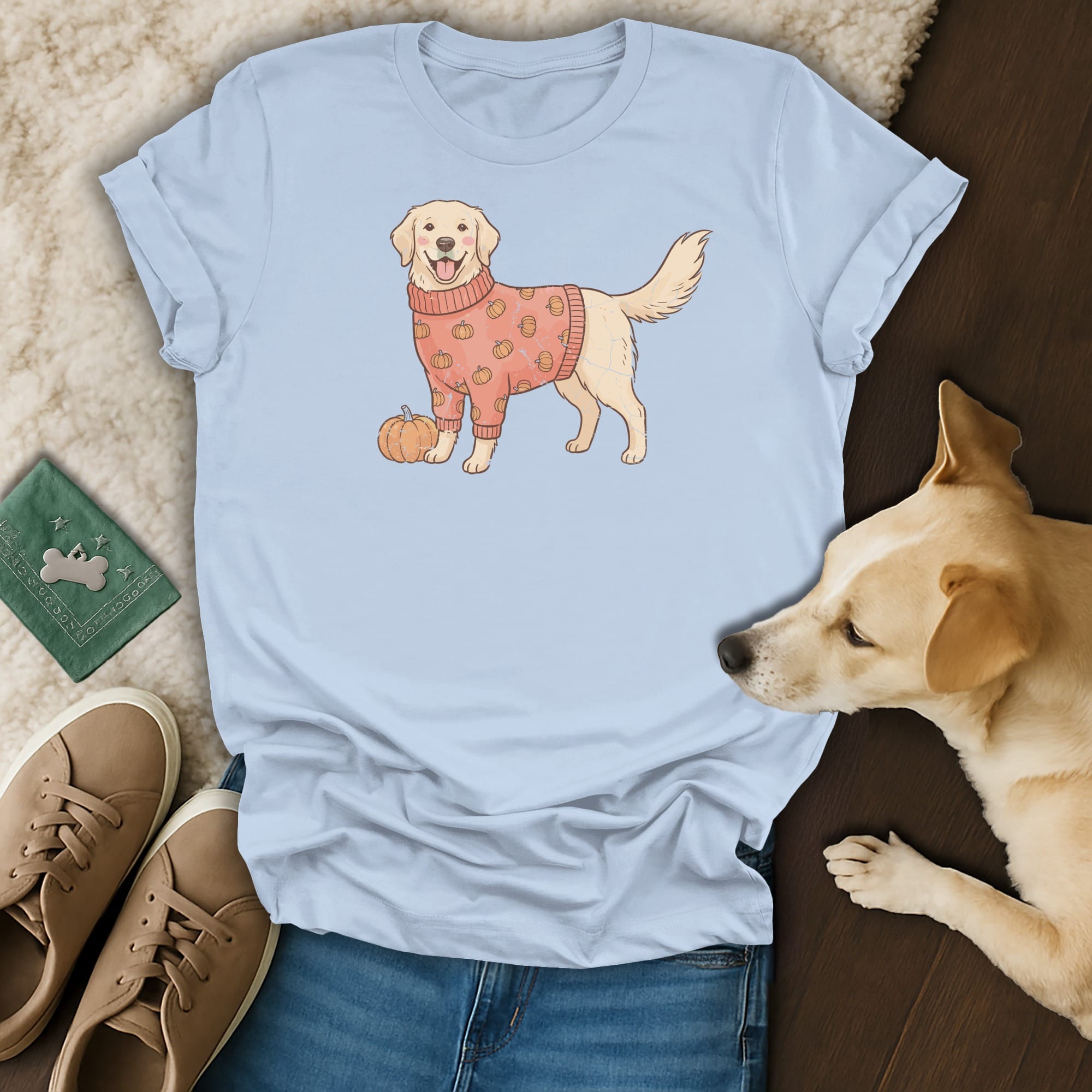Light blue t-shirt with a cartoon golden retriever wearing a pumpkin sweater.