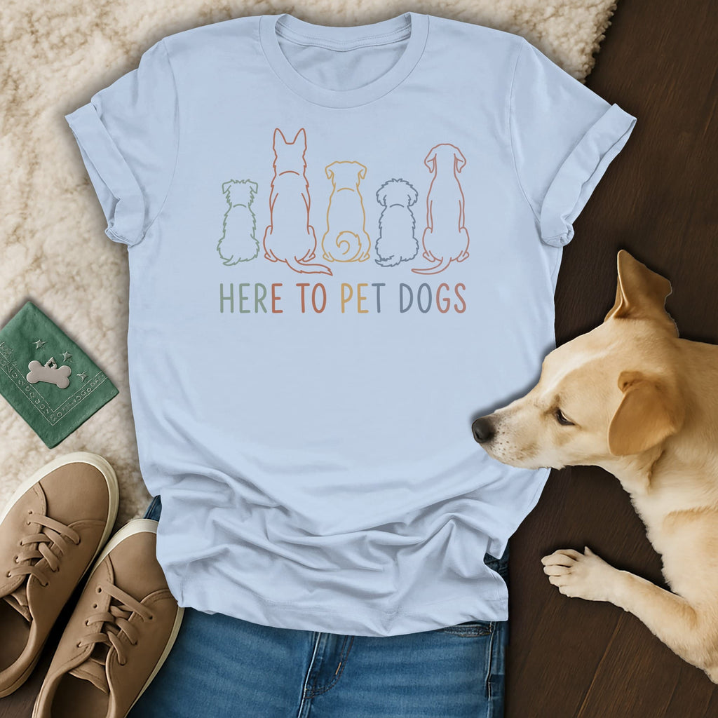Light blue t-shirt with colorful outlined dogs and text "HERE TO PET DOGS".