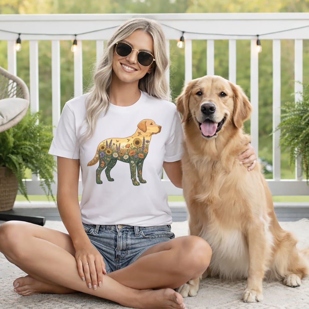 Woman wearing a t-shirt with a floral dog design poses with a golden retriever.