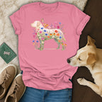 Pink t-shirt with a golden retriever silhouette filled with colorful wildflowers and a butterfly.