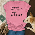 Pink t-shirt with black text "Humans" and one thumb-down star, and "Dogs" with five paw print stars.